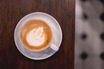 coffee on the wooden table from above. Urban coffee shop workspace or coffee break in morning.