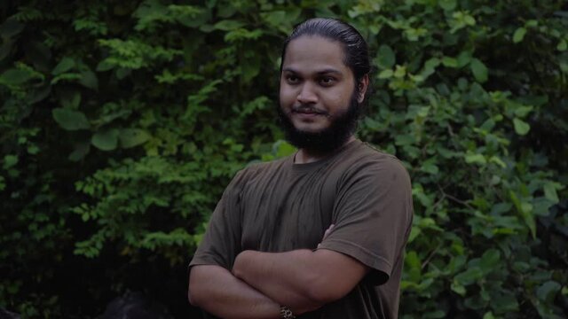 vivek bearded long hair man looking in camera smiling confident in jungle water