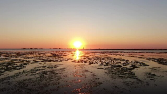 Stunning Orange Sunset Over Tidal Flat Of North Sea In Germany
