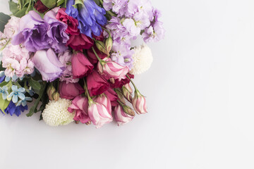 bouquet of pink and violet lisianthus flowers on white background.