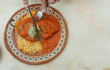 eating with cutlery authentic vegetarian Mexican chili, traditional mexican food, stuffed chili