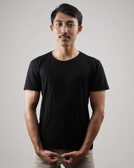 Obraz premium Young men in empty black T-shirts, stylish and posing like famous T-shirt models. Men's t-shirt template and mockup design for print. photo shoot models isolated white background.