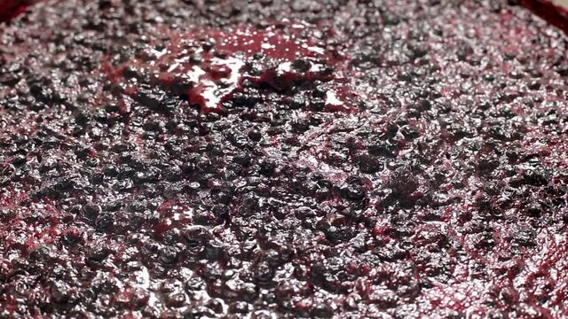 Boiling and cooking blueberry jam, background. Sweet and healthy food