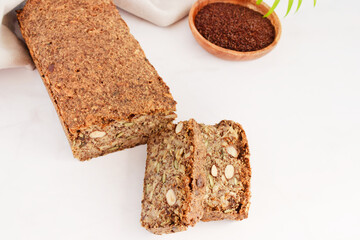 Homemade bread  on a wooden Board on light grey marble background close-up. Food for diet and health. Healthy almond bread, Keto, ketogenic diet, paleo, low carb fat, gluten-free.