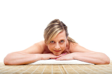 Matured naked woman lying on mattress