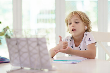 Online remote learning. School kids with computer.