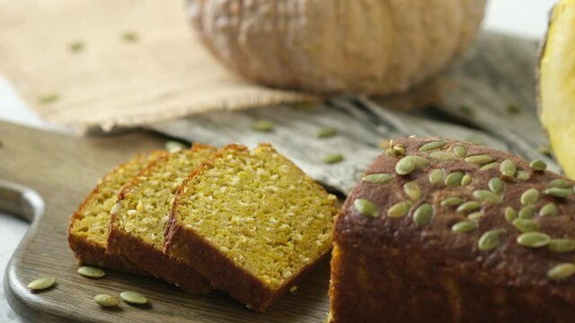 Gluten Free Pumpkin bread loaf set on white cafe table.