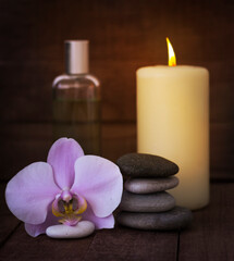 The concept of Zen and relaxation.Spa still life with a burning candle on a wooden background