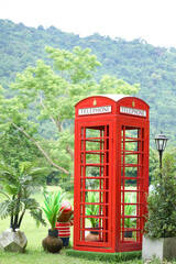 Obraz premium Telephone booth old red in the garden.