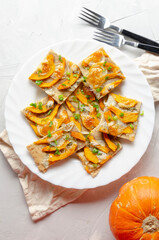 Tart from chopped dough with nuts with pumpkin, gorgonzola cheese. Baked.