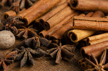 Obraz na płótnie Canvas Cinnamon, anise, nutmeg, on dark wooden background