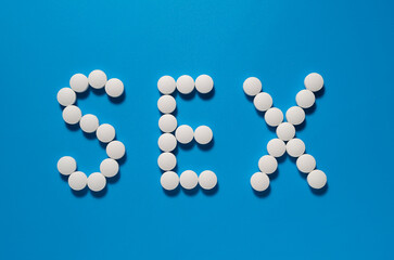 Word Sex written on blue background with pills