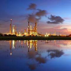 Industrial view of oil refinery factory with water reflection at sunrise, In the east of Thailand