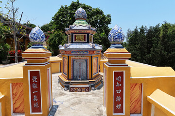Hoi An, Vietnam, May 3, 2020: Colorful mausoleum in the cemetery of the Chùa Phước Lâm temple. Hoi An, Vietnam