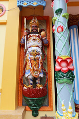 Hoi An, Vietnam, September 20, 2020: Colorful sculpture at the entrance door of the Cao Dai Taoist temple. Hoi An, Vietnam