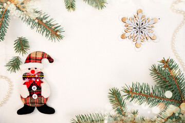 Snowman, snowflake, beads and spruce branch on a white background. New Year's picture.