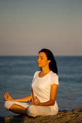 Fototapeta na wymiar Yoga concept. Female practicing yoga at the beach.