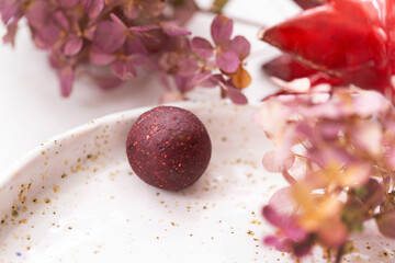 Candy of dried berries on a plate with a beautiful design