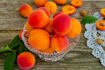 Ripe delicious apricots in a vase on the table