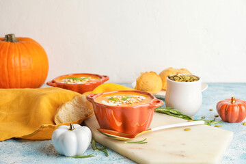 Tasty pumpkin cream soup in pot on table