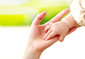 母親と赤ちゃんが手をつなぐ　親子の触れ合い