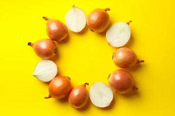 Fresh onion on yellow background, top view