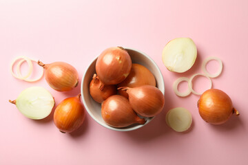 Bowl with fresh onion on pink background