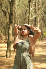 Naklejka premium Outdoor lifestyle portrait of beautiful young asian woman on the beach.