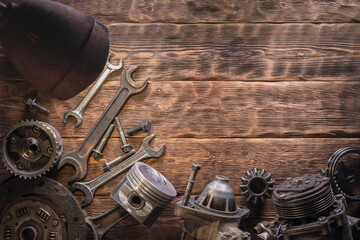 Auto mechanic workbench with old car spare parts and wrenches flat lay background.