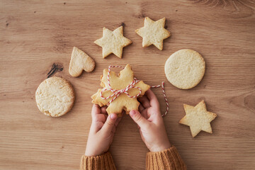 Top view detail of cookies held by hands of child