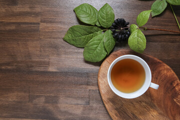 eleutherococcus on a wooden background with tea