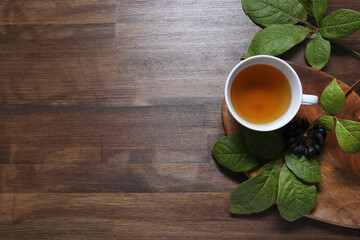 eleutherococcus on wooden background with tea
