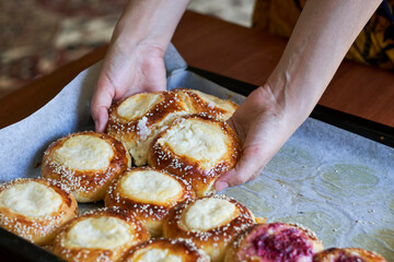 Freshly baked raspberry and cottage cheese buns on the oven pan
