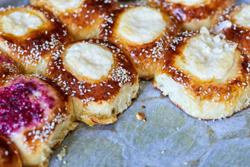 Freshly baked raspberry and cottage cheese buns on the oven pan