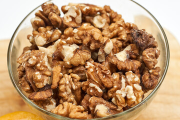 Peeled and cracked walnuts for snack. Close-up view of a bowl of walnuts.