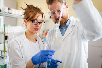 Young scientists, students of chemistry working in laboratory