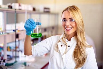 Attractive young woman scientist working in laboratory