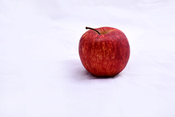 A red apple kept on a plain white background.