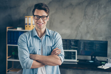 Close-up portrait of his he nice attractive cheerful cheery geek guy digital security top manager folded arms career growth at modern industrial interior style concrete wall work place station