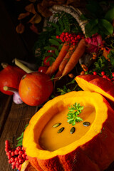 Delicious autumn pumpkin soup with baguette