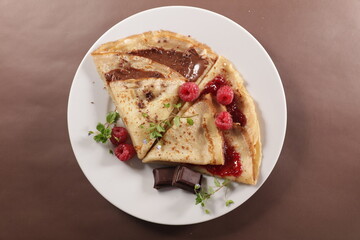 crepe with chocolate and berry fruit jam