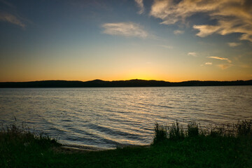Sunset on a lake in June with clouds