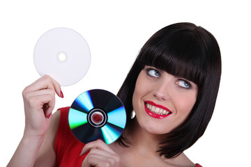 Woman holding compact discs on white background