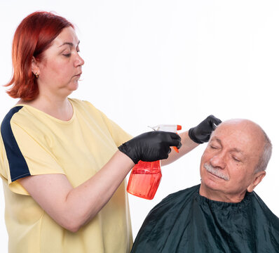 Senior Man Getting A Haircut Over White Background