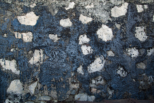 Textura de muro de pared con vertido de petr&oacute;leo y vertidos