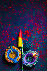 Diwali Diya with Fire Crackers over rangoli background