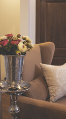 Living room interior, hookah in the form of a vase with flowers, red and white roses. Cozy English armchair with a pillow.