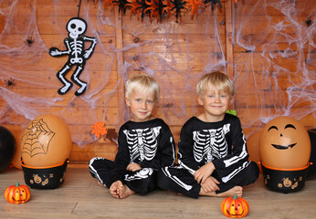 Two boys in skeleton costumes at Halloween party