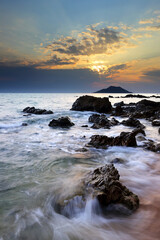 Obraz premium Dramatic seascape of Sea waves crashing against rocks in Krating Bay at beautiful sunset in Chanthaburi, Thailand, summer sea concept
