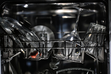 dishes in an open dishwasher, home style lifestyle, cleanliness and convenience background